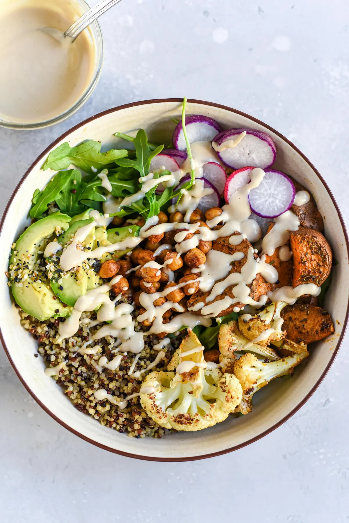 Grain bowl with roasted chickpeas, cauliflower and tahini